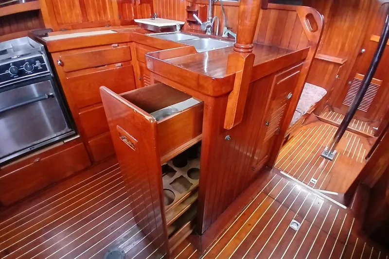 Slide: The Image of Wooden interior of 1980 Hardin 45 yacht kitchen with open drawer and stove. - 20