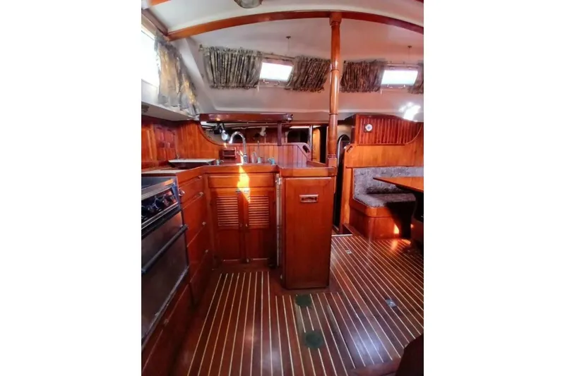 Slide: The Image of Interior of 1980 Hardin 45 sailboat with wooden cabinetry and seating area. - 21