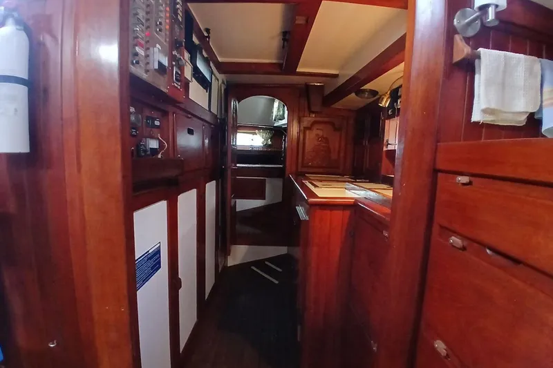 Slide: The Image of Interior of a 1980 Hardin 45 sailboat with wooden cabinetry and control panels. - 27