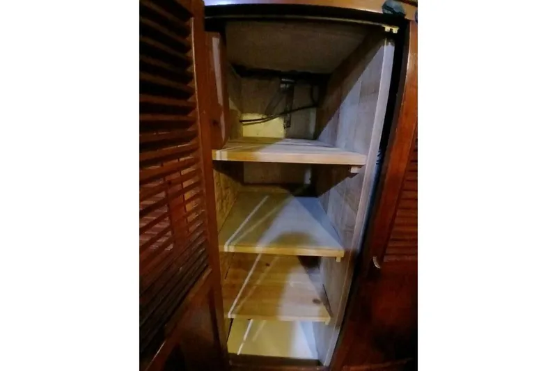 Slide: The Image of Wooden interior shelving inside a 1980 Hardin 45 model, featuring multiple storage compartments. - 32