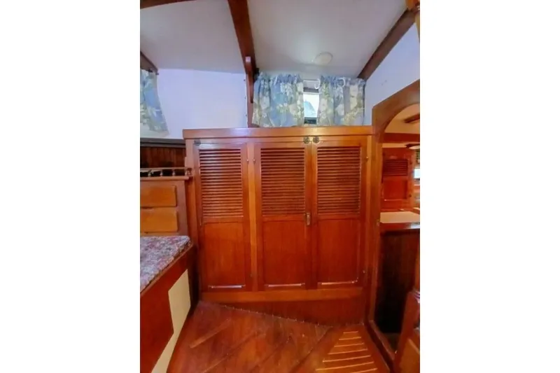 Slide: The Image of Interior of 1980 Hardin 45 sailboat with wooden cabinetry and floral curtains. - 33