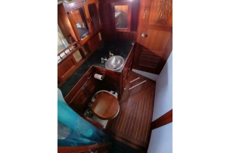 Slide: The Image of Interior of 1980 Hardin 45 boat featuring wooden cabinetry and compact bathroom. - 35