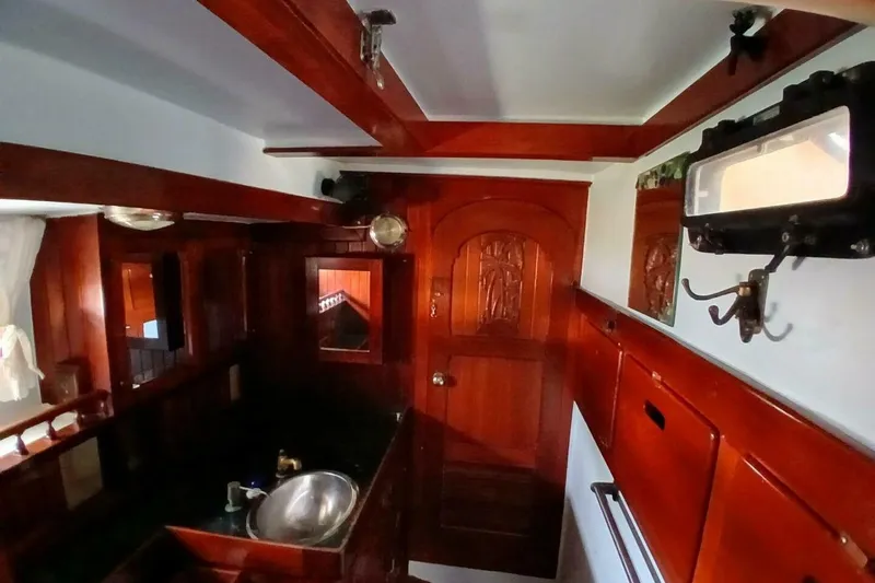 Slide: The Image of Interior of a 1980 Hardin 45 sailboat with rich wood finishes and nautical decor. - 36