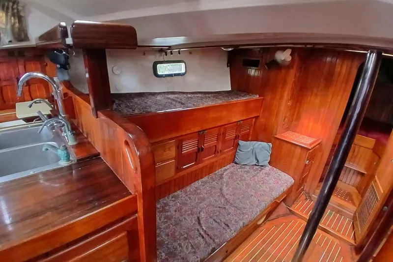 Slide: The Image of Interior of 1980 Hardin 45 sailboat with wooden finishes and cozy sleeping area. - 40