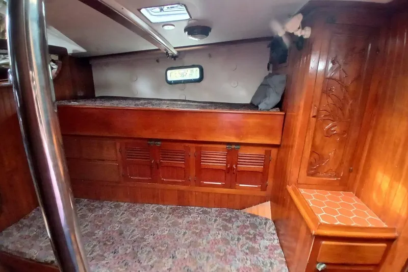 Slide: The Image of Cozy 1980 Hardin 45 yacht cabin with wooden interior and built-in storage. - 41