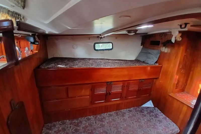 Slide: The Image of Cozy cabin interior of 1980 Hardin 45 sailboat with wooden furnishings and bedding. - 43