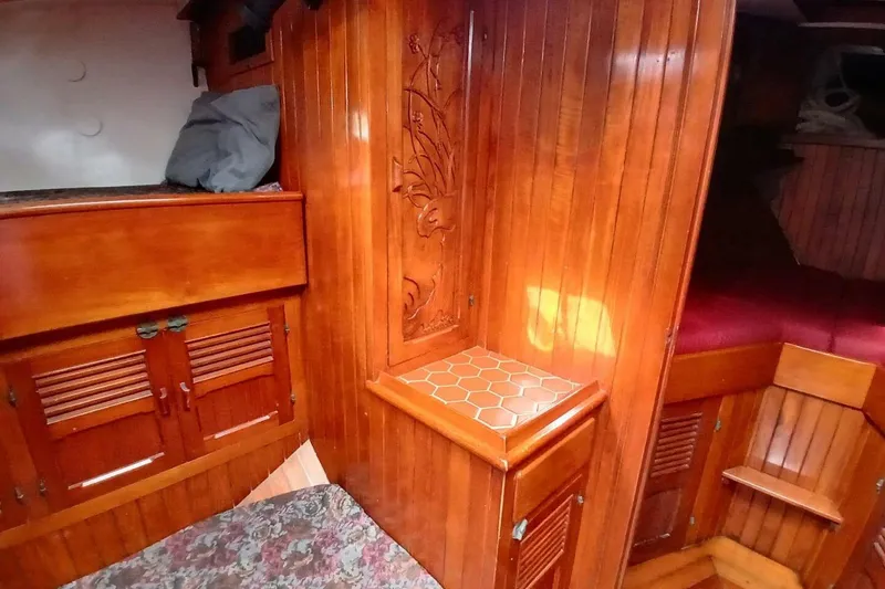 Slide: The Image of Wood-paneled interior of 1980 Hardin 45 yacht with carved details and hexagonal tile accents. - 44