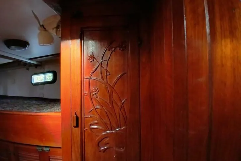 Slide: The Image of Interior of 1980 Hardin 45 sailboat with carved wooden door and cozy cabin. - 45