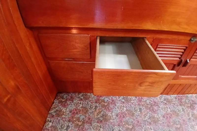 Slide: The Image of Wooden interior of a 1980 Hardin 45 boat with an open drawer. - 48