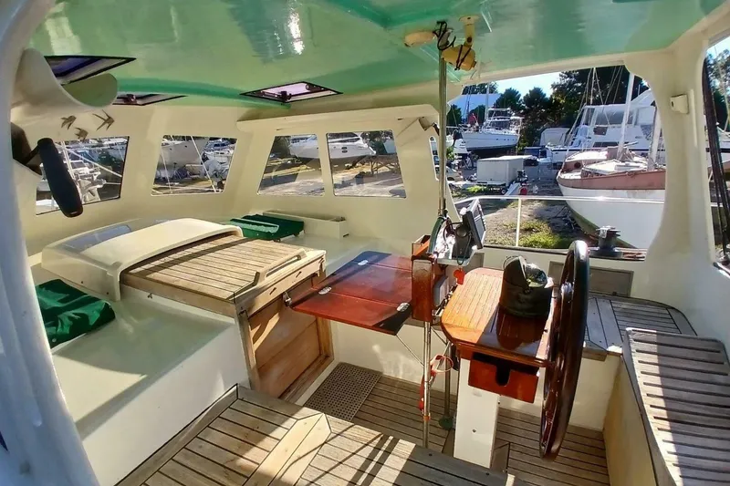 Slide: The Image of Interior of 1980 Hardin 45 sailboat with wooden helm and seating area. - 5