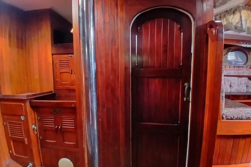 Slide: The Image of Interior of 1980 Hardin 45 sailboat with rich wooden paneling and cozy cabin features. - 50