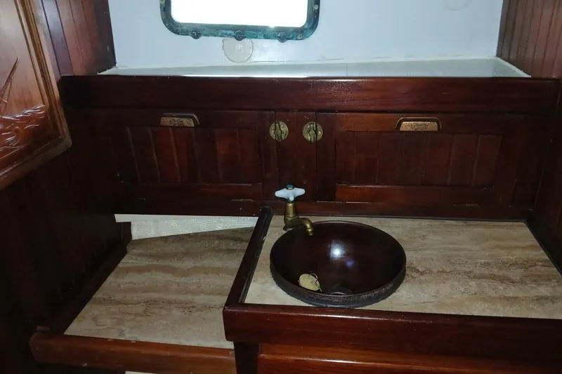 Slide: The Image of Wooden interior of 1980 Hardin 45 boat with sink and cabinets. - 52