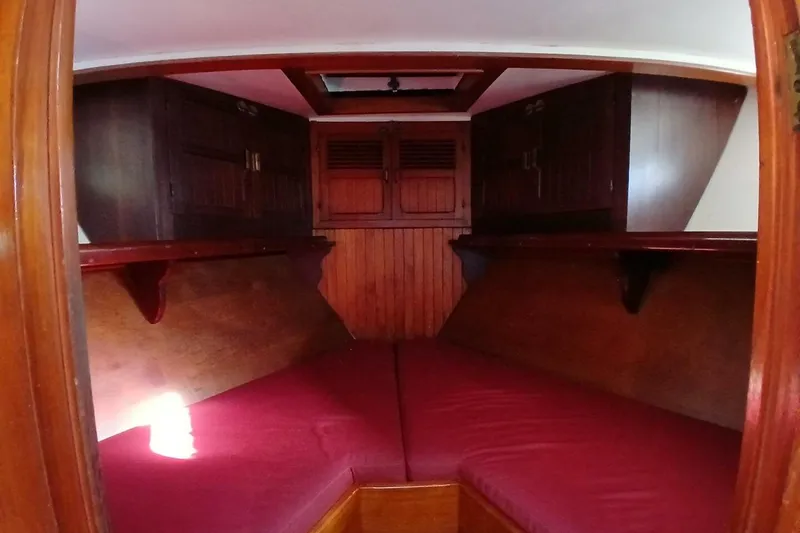 Slide: The Image of Interior cabin of 1980 Hardin 45 sailboat with red cushions and wooden cabinetry. - 54