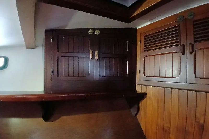 Slide: The Image of Interior of a 1980 Hardin 45 sailboat with wooden cabinets and paneling. - 56