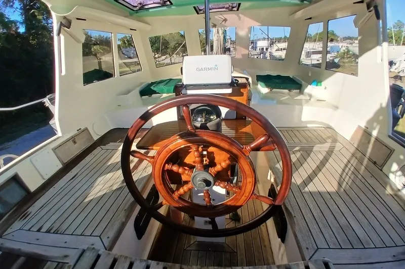 Slide: The Image of Interior of 1980 Hardin 45 sailboat with wooden steering wheel and Garmin navigation system. - 72