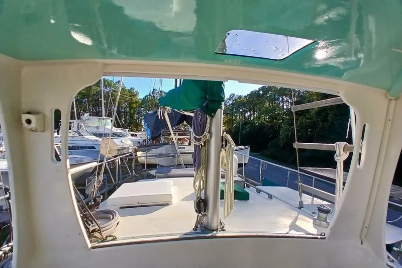 Slide: The Image of 1980 Hardin 45 sailboat deck view with marina background. - 73