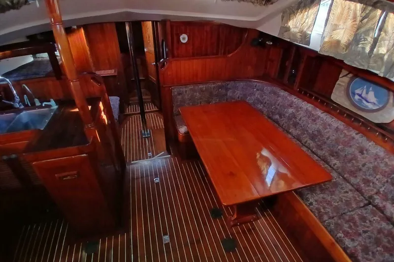 Slide: The Image of Interior of 1980 Hardin 45 sailboat with wooden furnishings and cozy seating area. - 8
