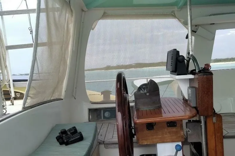 Slide: The Image of Interior view of 1980 Hardin 45 sailboat cockpit with steering wheel and navigation equipment. - 84