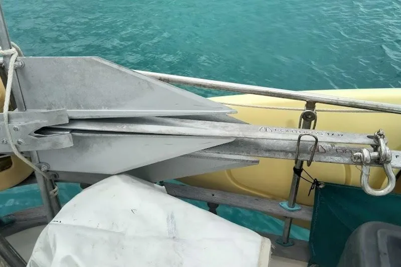 Slide: The Image of Anchor on a 1980 Hardin 45 sailboat, with turquoise water background. - 89