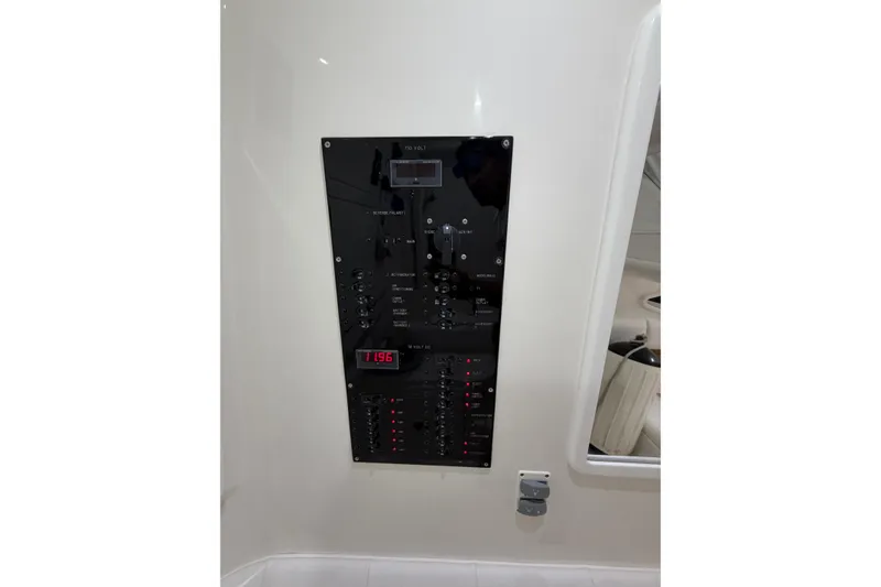 Slide: The Image of Control panel of 2025 Deep Impact 369 Sport boat, featuring various switches and indicators. - 10