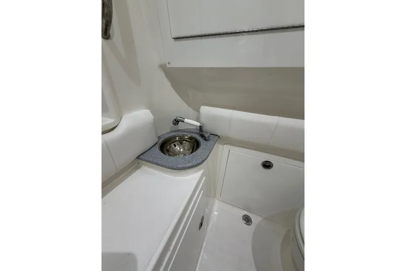Slide: The Image of Compact bathroom sink area in 2025 Deep Impact 369 Sport boat. - 13
