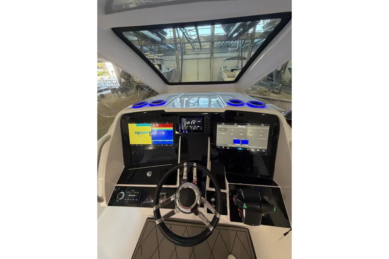 Slide: The Image of Cockpit of 2025 Deep Impact 369 Sport boat with advanced navigation displays. - 15
