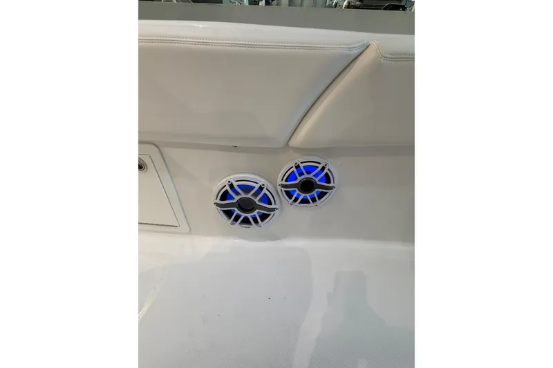 Slide: The Image of 2025 Deep Impact 369 Sport boat interior with blue-lit speakers. - 16