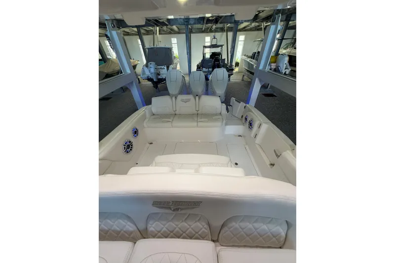 Slide: The Image of 2025 Deep Impact 369 Sport boat interior with luxurious white seating and modern design. - 18