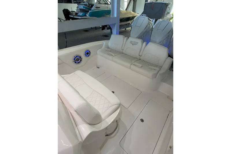 Slide: The Image of 2025 Deep Impact 369 Sport boat interior with white seating and speakers. - 21