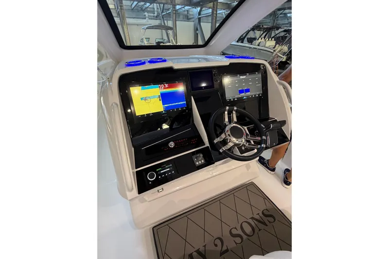 Slide: The Image of 2025 Deep Impact 369 Sport boat dashboard with advanced navigation displays and steering wheel. - 22