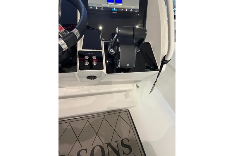Slide: The Image of Control panel of 2025 Deep Impact 369 Sport boat with steering wheel and throttle. - 25