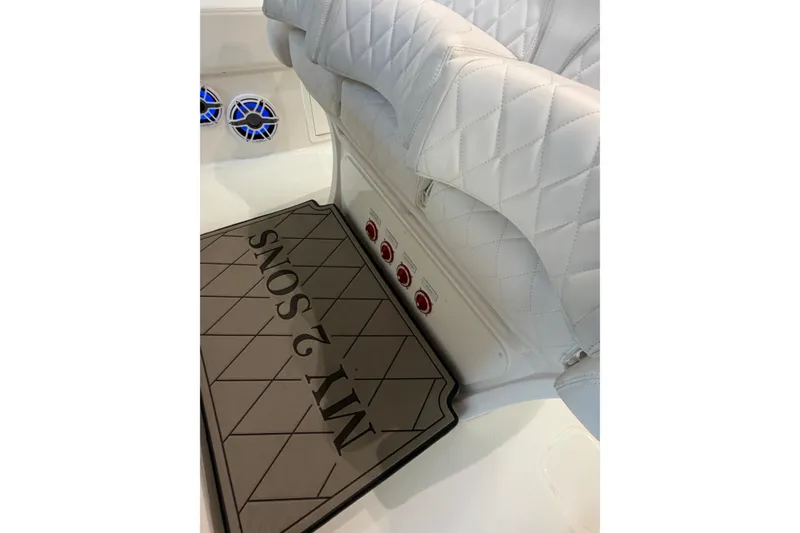 Slide: The Image of Luxurious white seating in 2025 Deep Impact 369 Sport boat interior, featuring custom mat design. - 26