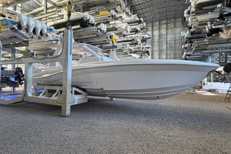 Slide: The Image of 2025 Deep Impact 369 Sport boat in storage facility, surrounded by other boats. - 29