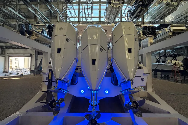 Slide: The Image of Triple outboard engines on a 2025 Deep Impact 369 Sport boat in a storage facility. - 32