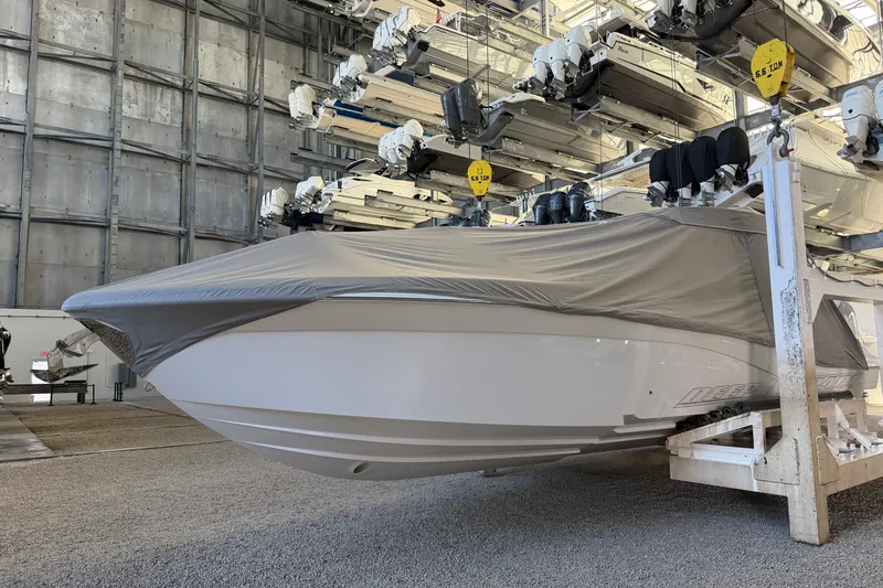 Slide: The Image of 2025 Deep Impact 369 Sport boat in storage, covered, with multiple boats stacked above. - 36
