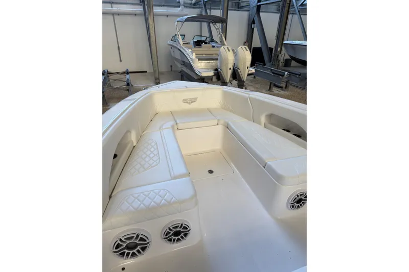Slide: The Image of 2025 Deep Impact 369 Sport boat interior with white seating and speakers. - 39
