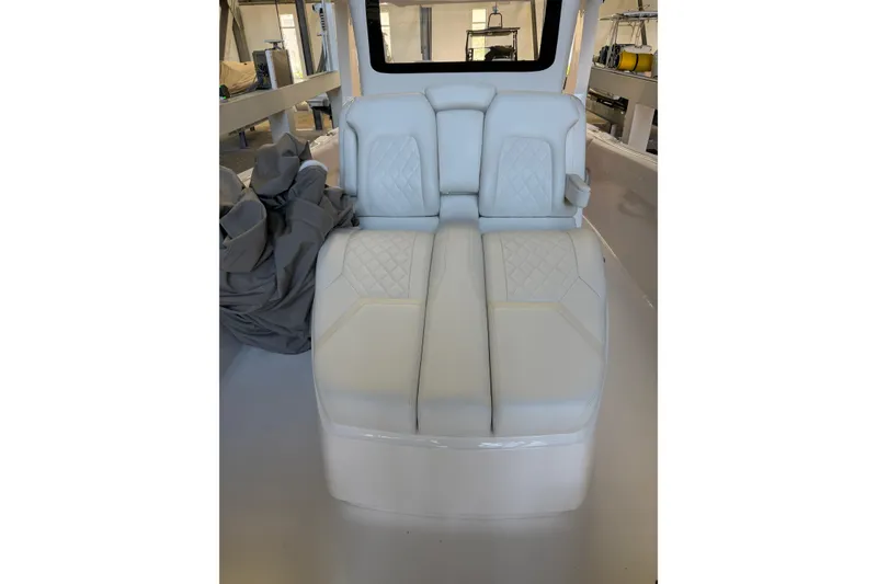 Slide: The Image of 2025 Deep Impact 369 Sport boat interior with white cushioned seating. - 40