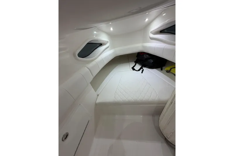 Slide: The Image of Interior cabin of 2025 Deep Impact 369 Sport boat, featuring white seating and modern design. - 7