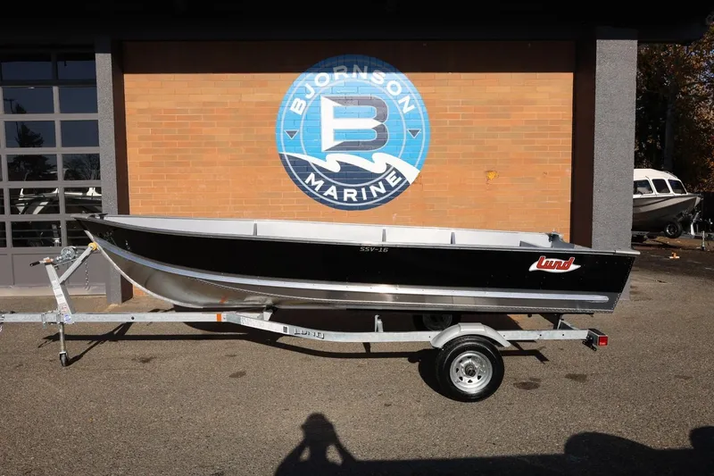 The Image of 2026 Lund SSV-16 Tiller boat on trailer at Bjornson Marine dealership. - 1