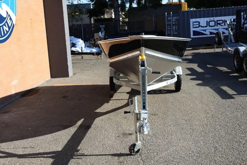 Slide: The Image of 2026 Lund SSV-16 Tiller boat on trailer in outdoor setting. - 11