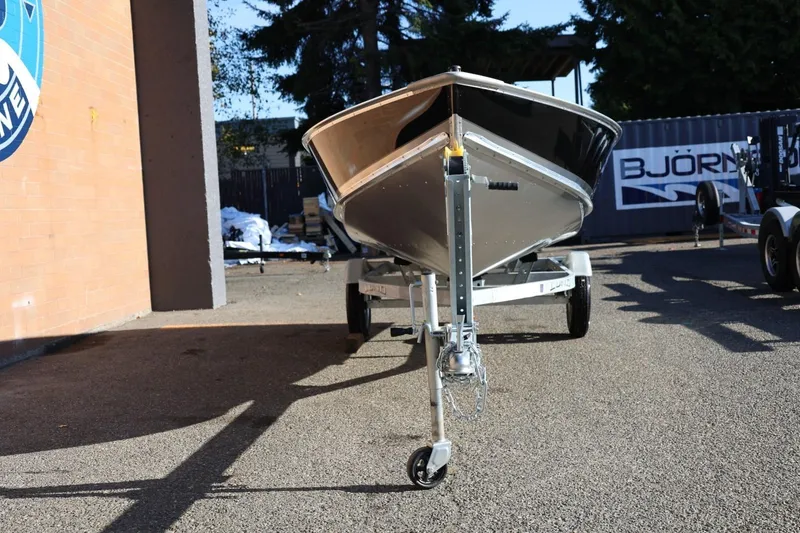 Slide: The Image of 2026 Lund SSV-16 Tiller boat on trailer, parked outdoors. - 12