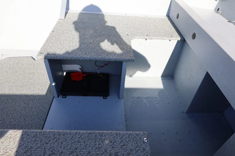 Slide: The Image of 2026 Lund SSV-16 Tiller boat interior with storage compartment and shadow. - 17