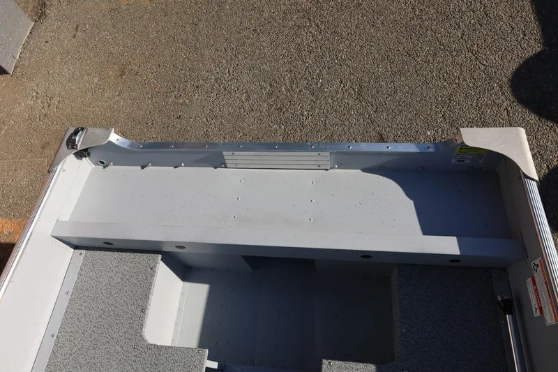 Slide: The Image of 2026 Lund SSV-16 Tiller boat interior, showcasing seating and storage area. - 22