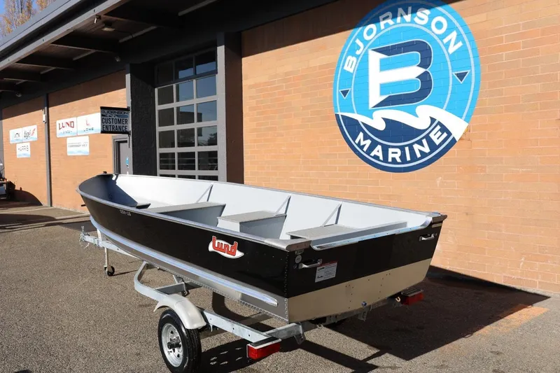 Slide: The Image of 2026 Lund SSV-16 Tiller boat on trailer at Bjornson Marine dealership. - 3