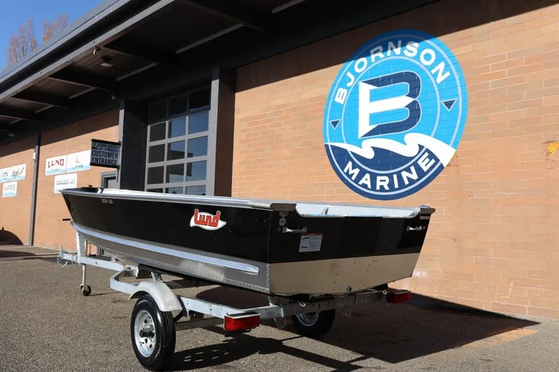 Slide: The Image of 2026 Lund SSV-16 Tiller boat on trailer at Bjornson Marine dealership. - 4