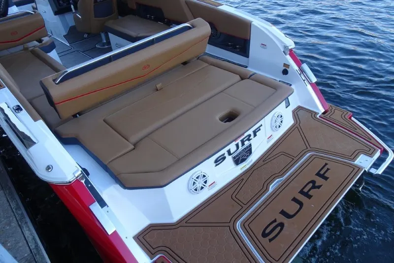 Slide: The Image of 2026 Cobalt R8 Surf boat with tan seating and "Surf" branding on deck. - 11
