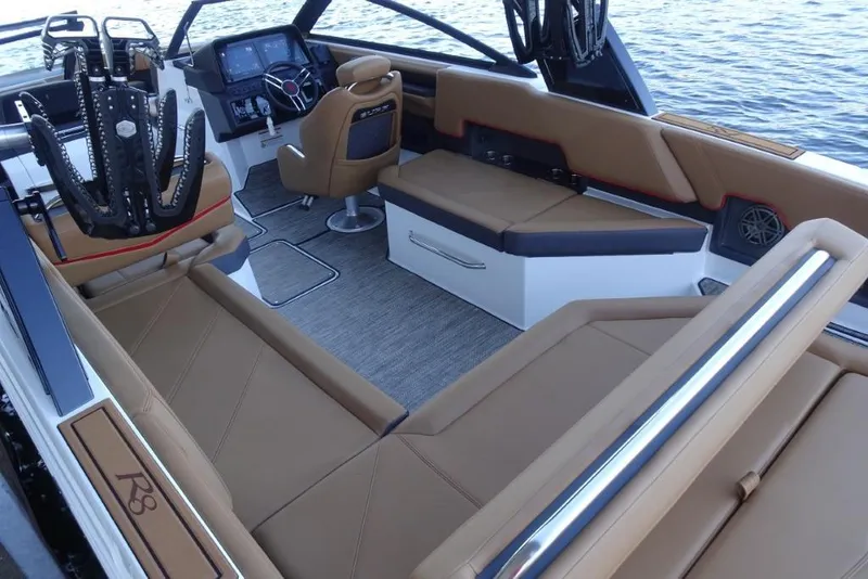 Slide: The Image of Luxurious interior of 2026 Cobalt R8 Surf boat with tan seating and modern dashboard. - 12
