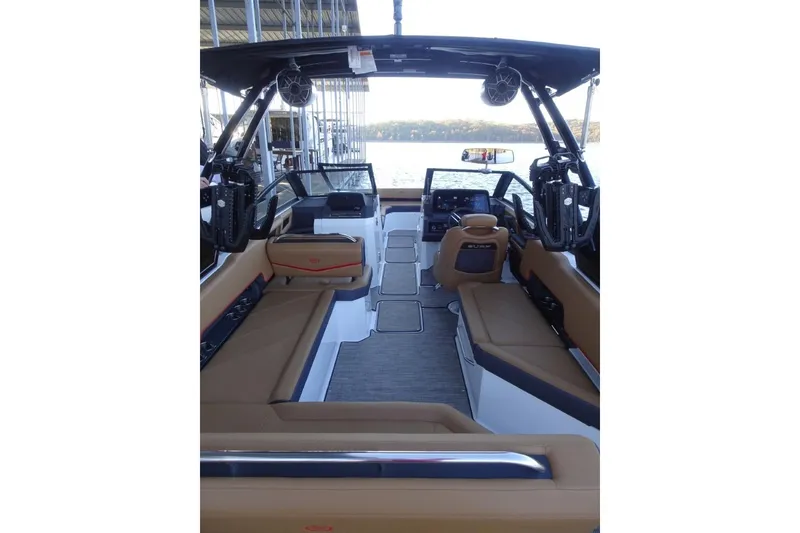 Slide: The Image of 2026 Cobalt R8 Surf boat interior with tan seating and modern dashboard. - 13