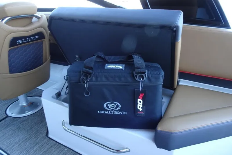 Slide: The Image of 2026 Cobalt R8 Surf boat interior with branded cooler bag on seat. - 16