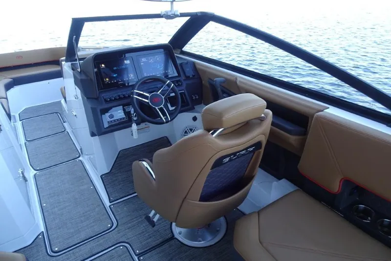 Slide: The Image of 2026 Cobalt R8 Surf boat interior with modern dashboard and tan seating. - 17